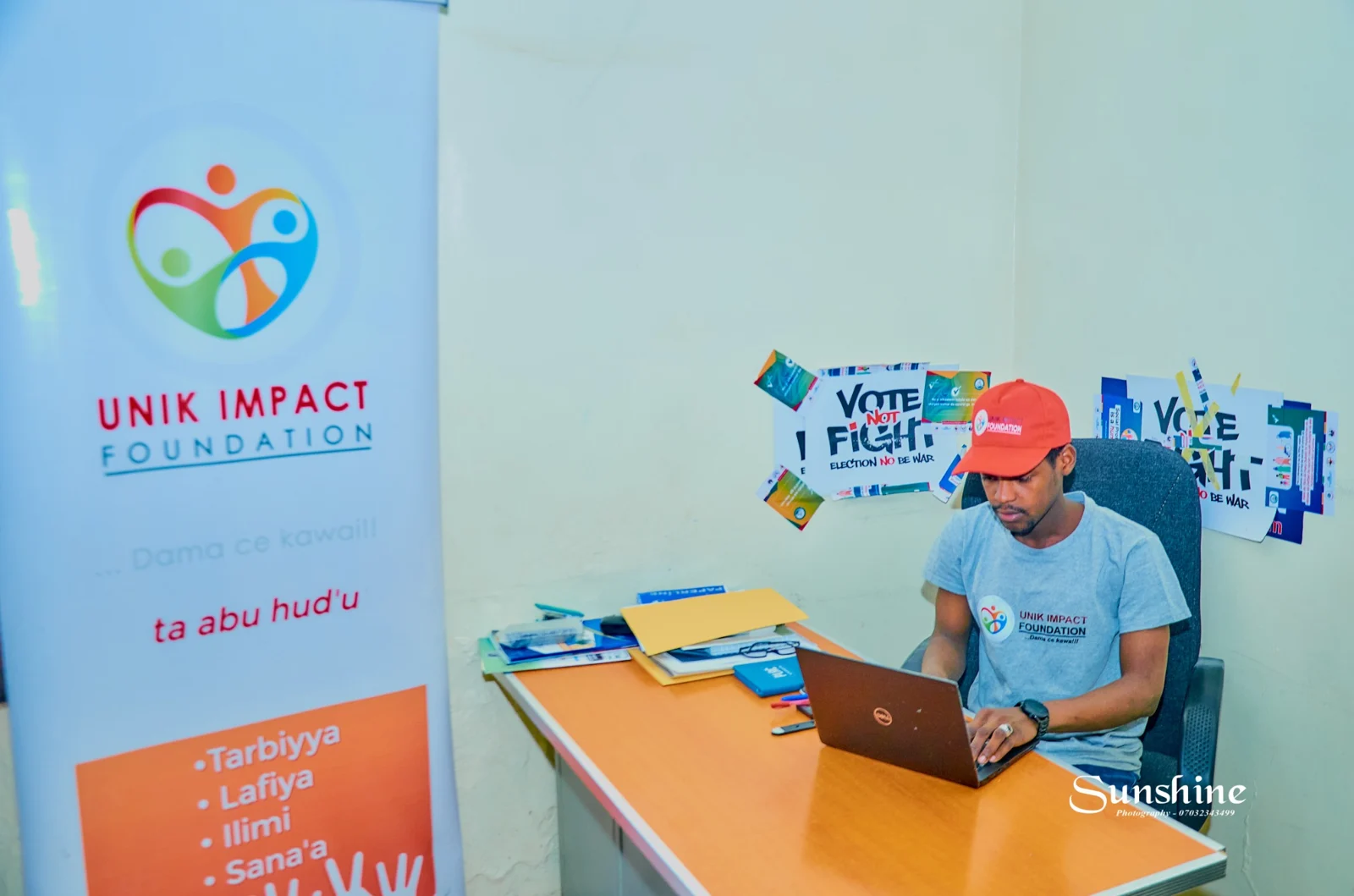 Office photograph showing Unik Impact Foundation branding